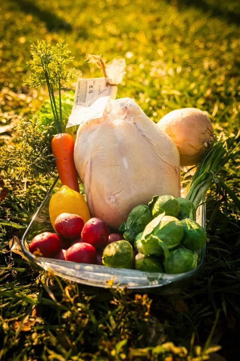 Pasture-raised chicken and fresh vegetables on the market table
