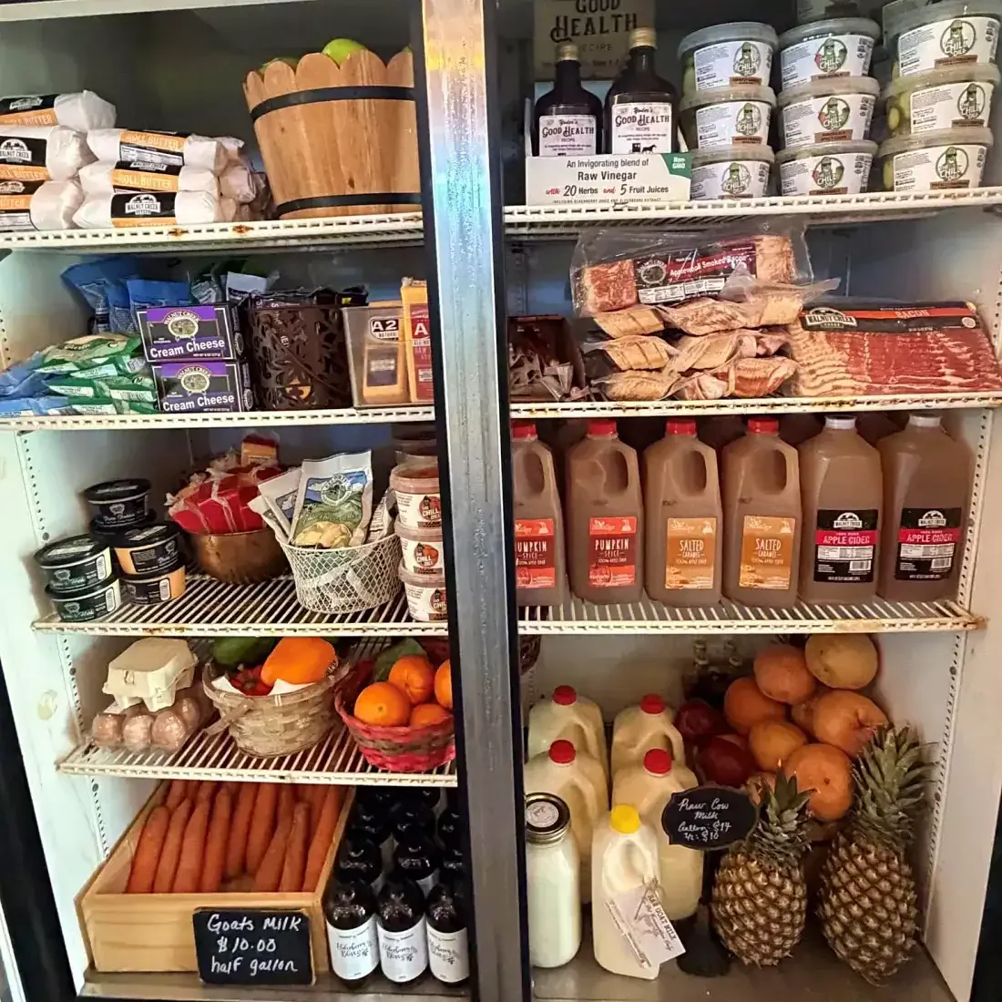 Market cooler stocked with Heartland milk, eggs, meats and produce