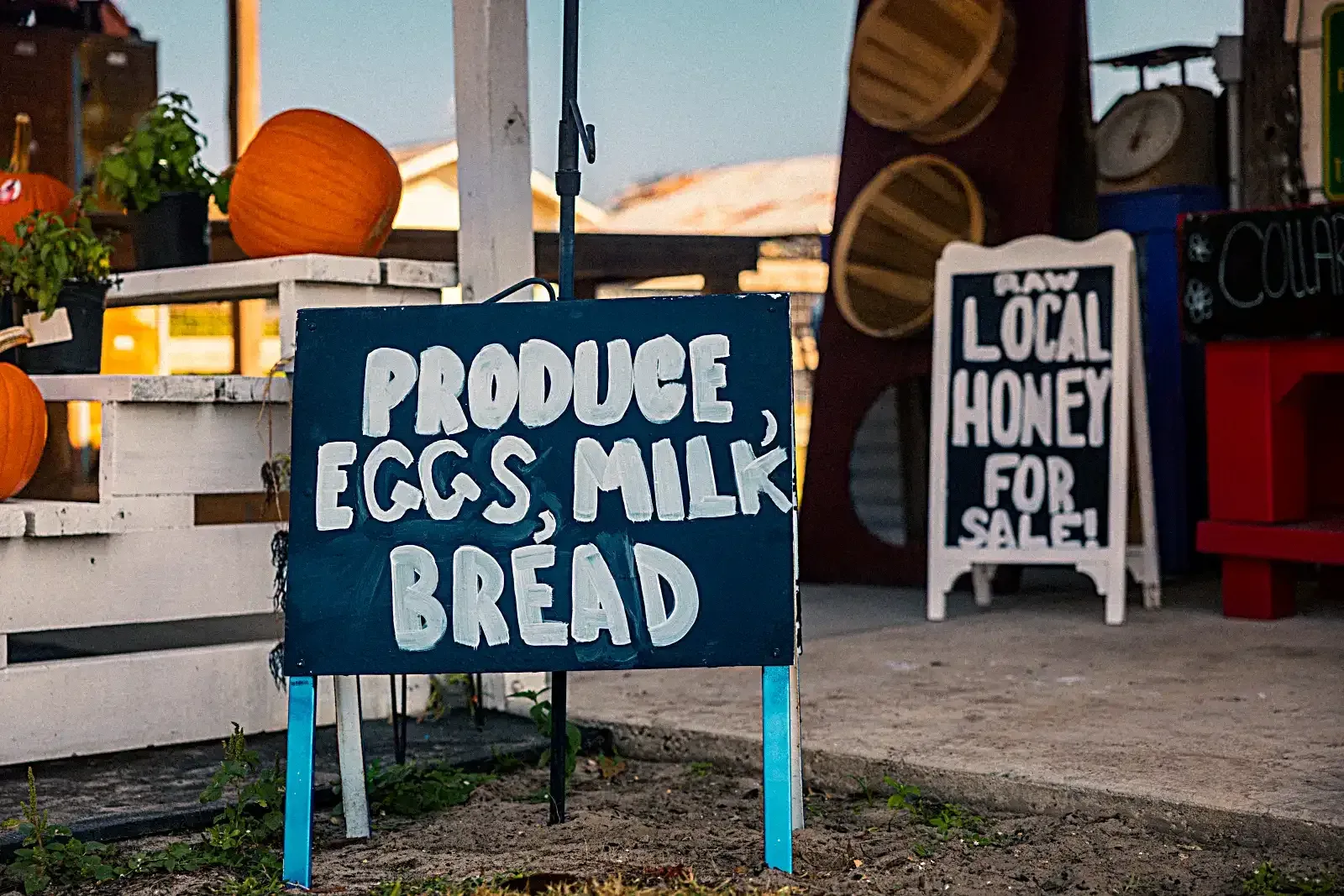 Market sign reading Produce, Eggs, Milk, Bread and Local Honey for Sale