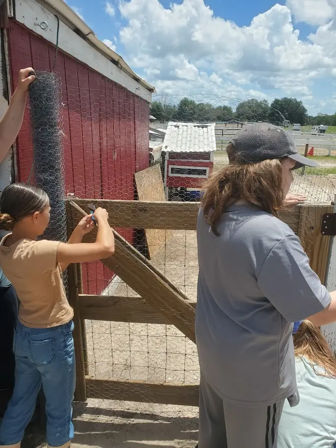 Students working on farm infrastructure and learning practical stewardship skills